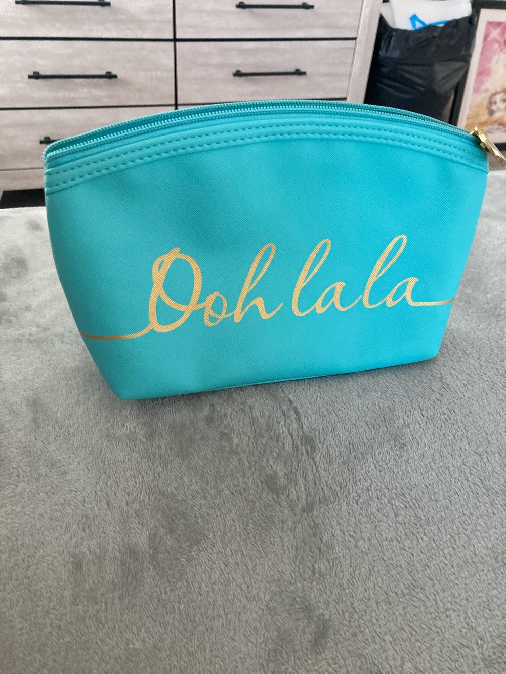 Turquoise colored faux leather cosmetic bag